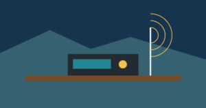 Abstract tabletop amateur-radio set with antenna and radio waves against Colorado mountains.