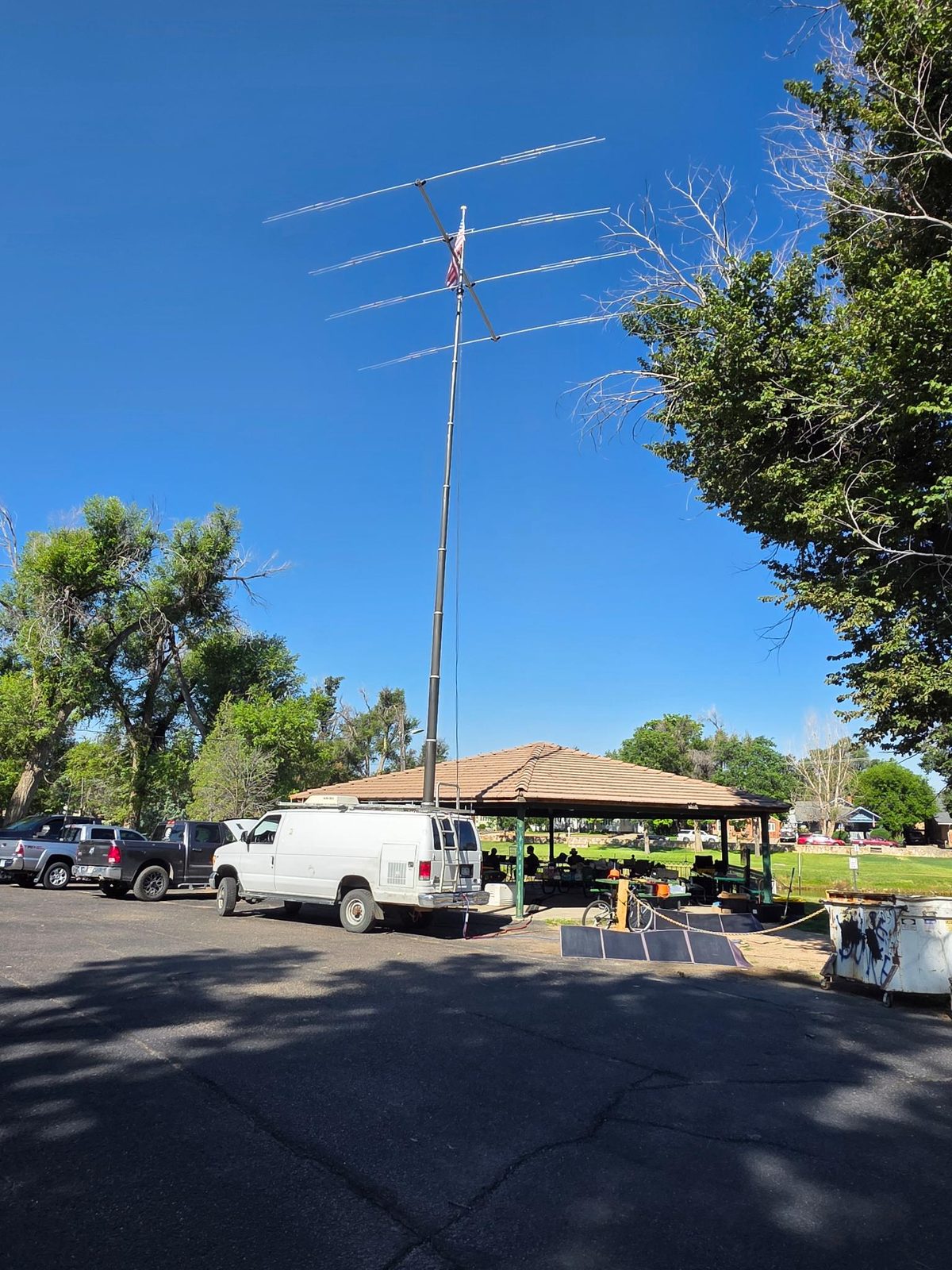 HF beam antenna up over the pondside gazebo at La Junta City Park, with the EOC van alongside.