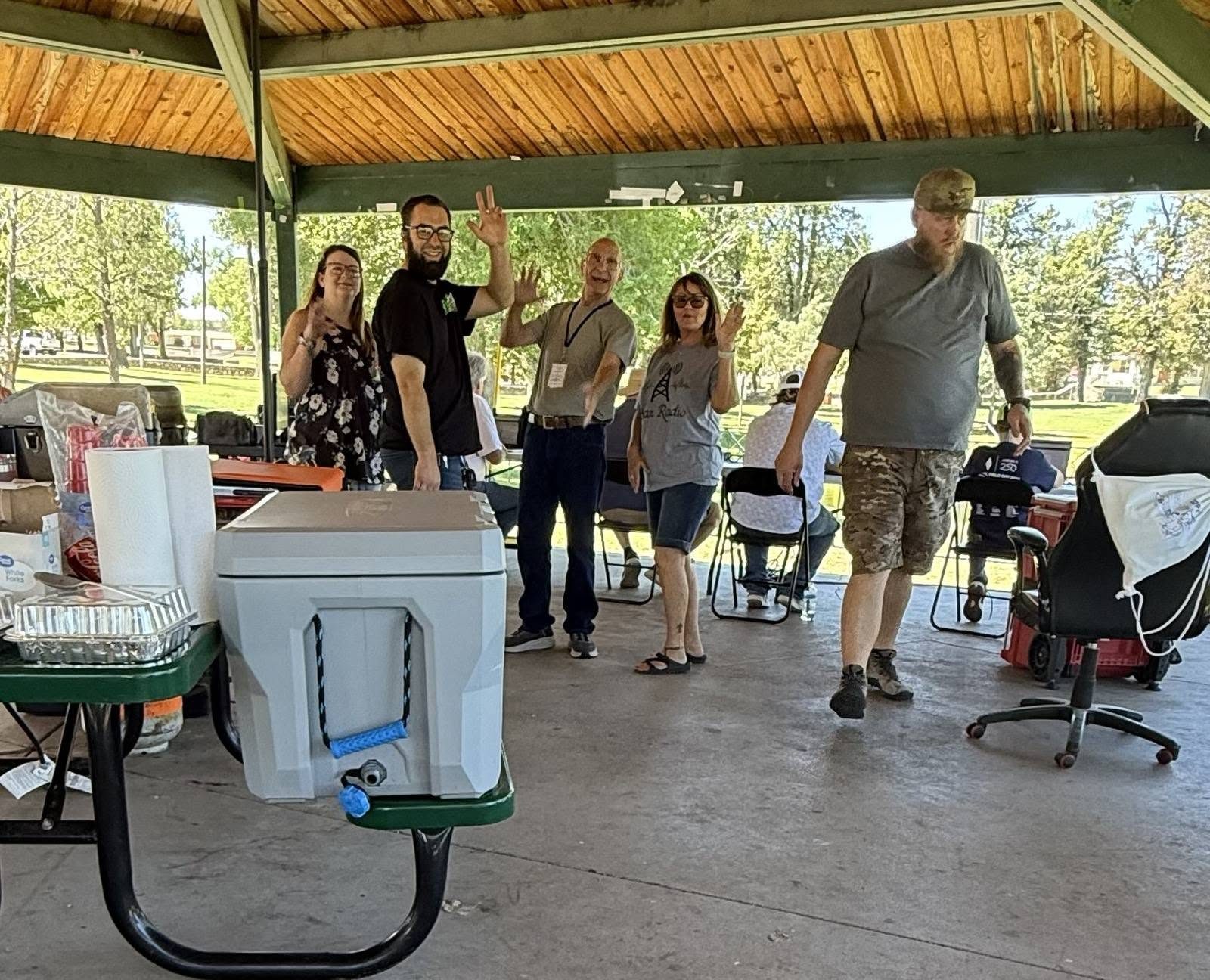 Members gathered under the gazebo by the coolers.