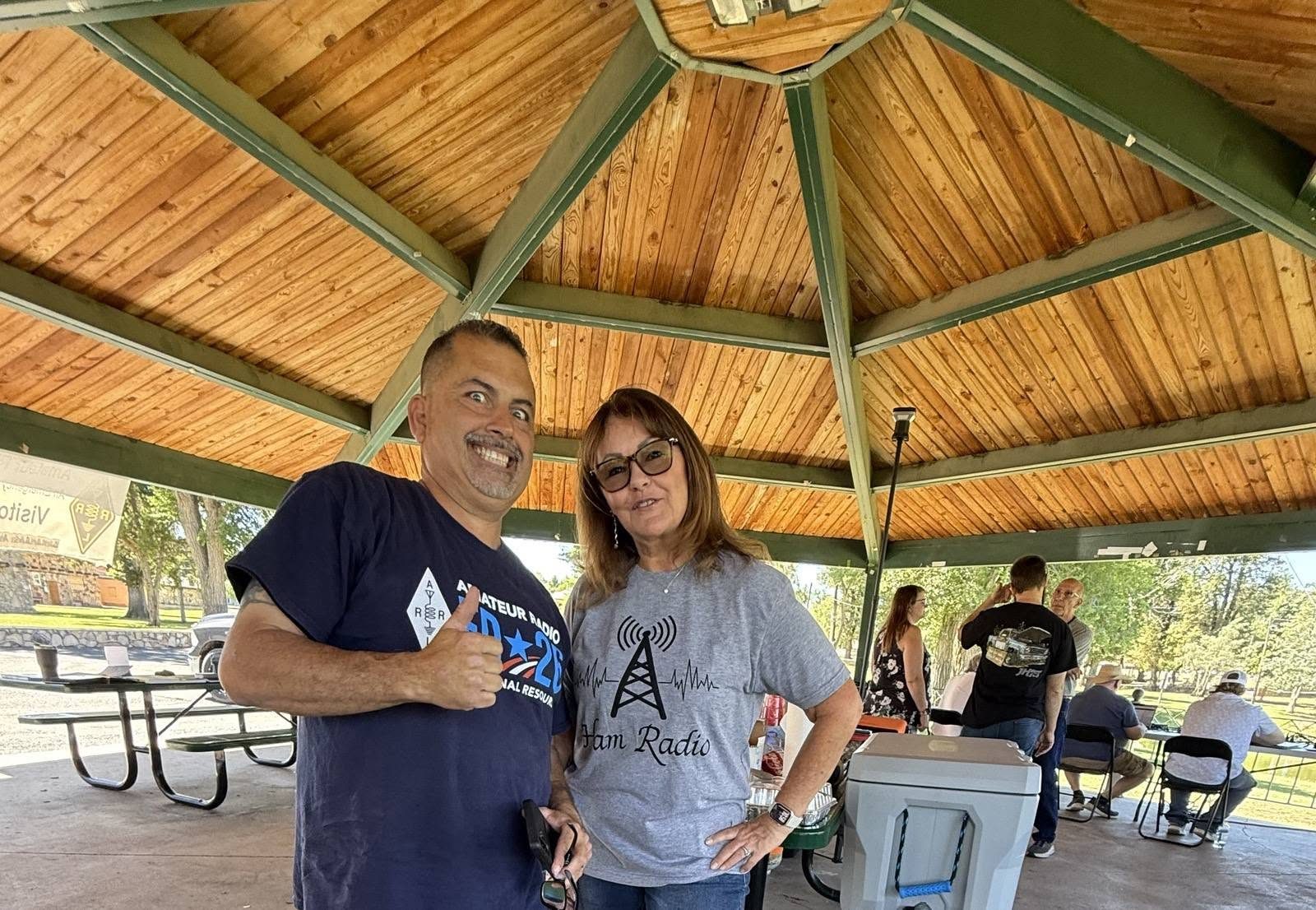 Two members share a laugh under the gazebo.